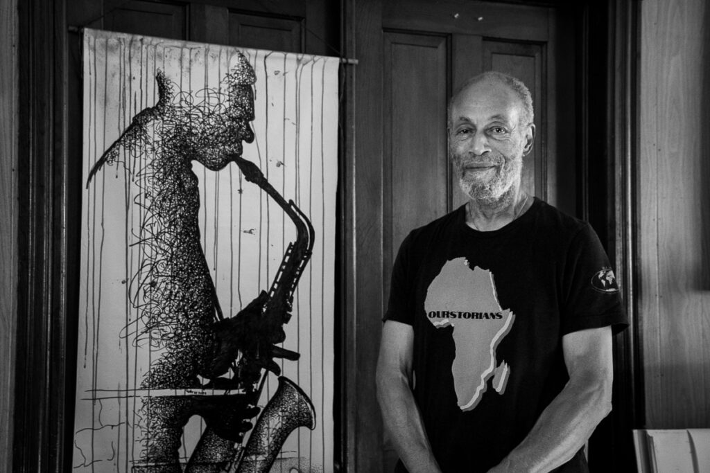 Artist Charles Trott of Asbury Park, NJ. Photo taken next to one of his pieces of art to appear on a community banner. https://www.proartsjerseycity.org/artist/charles-trott/