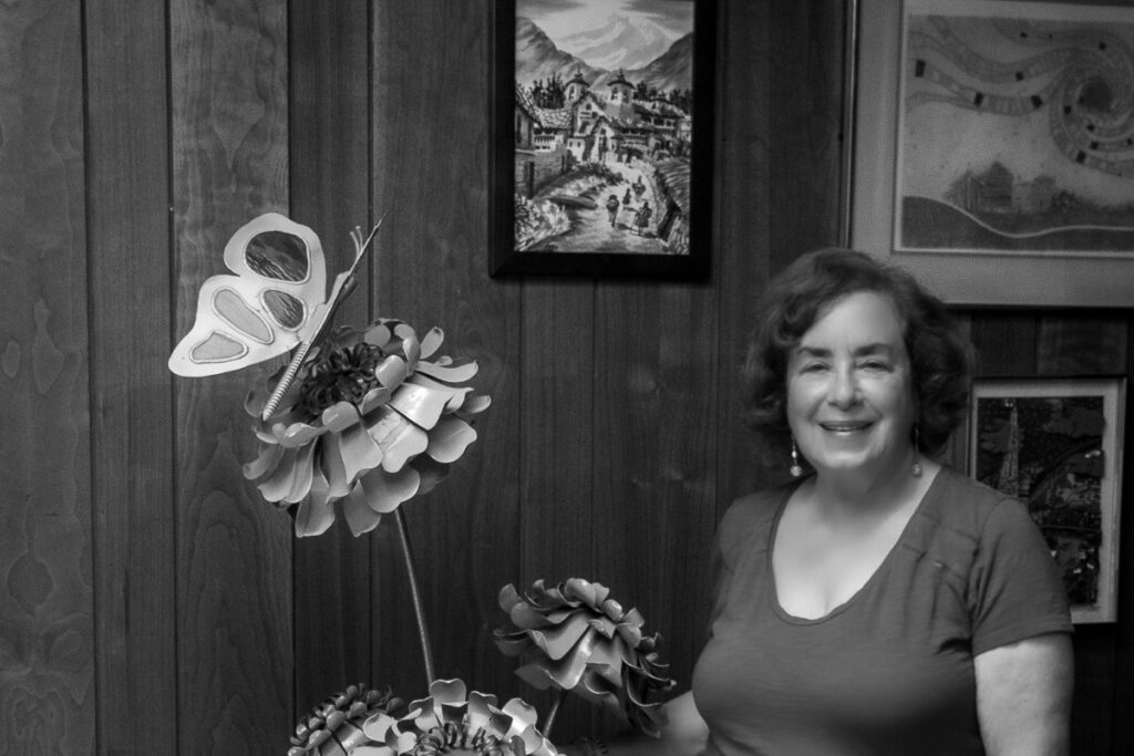 Lynn Reich is a Past Board President of Monmouth Council Arts Council. She is photographed here next to her favorite sculpture.